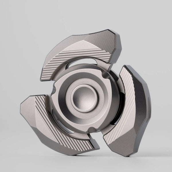 Machined spinner category object centered on a warm light surface