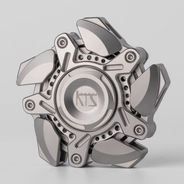 Machined spinner category object centered on a warm light surface